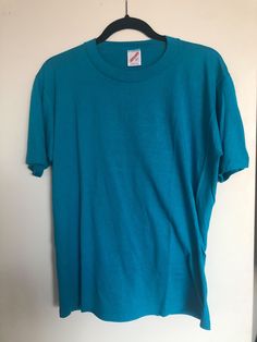 Vintage 80s Blue turquoise Jerzees plain t-shirt Size L.  Good vintage condition. Cheap 90s Style Blue Shirt, Turquoise Crew Neck T-shirt For Summer, 90s Blue Crew Neck Top, Vintage Short Sleeve T-shirt, Turquoise Cotton Crew Neck T-shirt, Casual Turquoise Crew Neck T-shirt, Turquoise Cotton Short Sleeve T-shirt, Vintage Blue Short Sleeve Tops, Retro Crew Neck Solid Tops