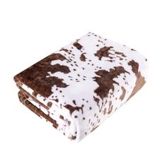 a brown and white cow print blanket