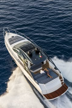 a white and brown boat traveling through the ocean