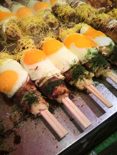 several skewers of food with eggs on them