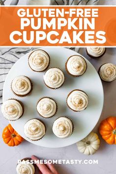 gluten - free pumpkin cupcakes with white frosting on a plate