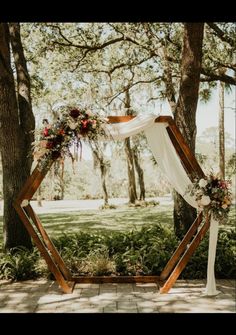 a wedding arch decorated with flowers and greenery