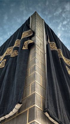 the top of a tall building with a black cloth covering it's roof and windows