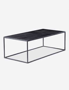 a black table sitting on top of a white floor