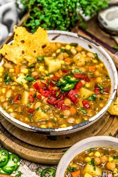 a white bowl filled with soup next to some tortilla chips