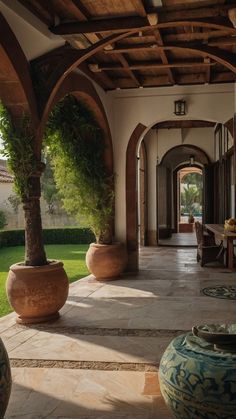 an outdoor area with potted plants and large vases