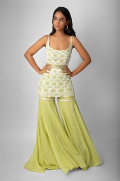 Jade green short kurta with hand embroidered geometric motif bead-crystal work and cutwork detail. Comes with organza sharara and embellished belt. Component: 3 Embroidered Neckline: U Neck Sleeve Length: Sleeveless Fabric: Crepe Silk, Net, Double Georgette, Organza Color: Green Cutwork detail Noodle straps - Aza Fashions Grara Dress, Ritika Mirchandani, Organza Sharara, Mehendi Outfit, Sharara Designs, Kurta Sharara Set, Kurta Sharara, Long Kurti Designs