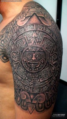 the back of a man's arm with an intricate tattoo design on his shoulder