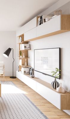 a living room filled with furniture and a flat screen tv mounted on a wall next to a window