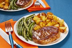 two plates with meat, potatoes and green beans