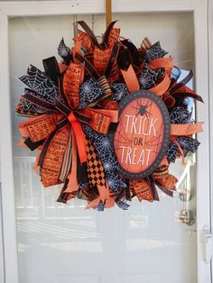 a trick or treat wreath hanging on the front door