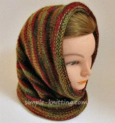 a mannequin head wearing a multicolored knitted cowl scarf and hat