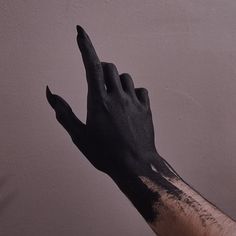 a person's hand with black paint on it