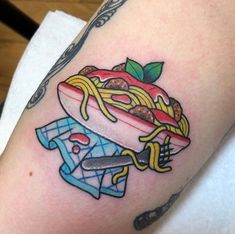 a tattoo with noodles and an apple on it