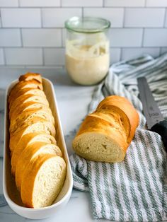 a loaf of bread sitting on top of a counter next to a knife and bowl