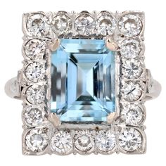 Ring in 18 karat white gold. Sumptuous antique ring of rectangular shape, it presents in the center a degrees- cut aquamarine retained with 4 claws, in a surrounding of modern brilliant- cut diamonds. The flat basket is openworked at the back and two rose-cut diamonds adorn, on either side, the start of the ring. Weight of the aquamarine : 2.58 carats approximately. Weight of the diamonds : about 1.10 carats. Height : 16.8 mm, width : 14.3 mm, thickness : 6.2 mm, width of the ring at the base : Flat Basket, Antique Ring, Estilo Art Deco, Antique Art Deco, Rose Cut Diamond, Jewelry Rings Engagement, Antique Rings, Brilliant Cut Diamond, Rose Cut