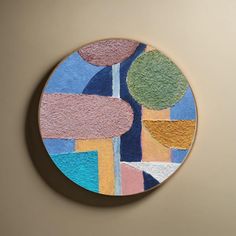 a circular painting on the wall with different colors