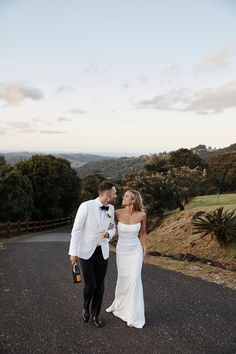 a newly married couple walking down the road