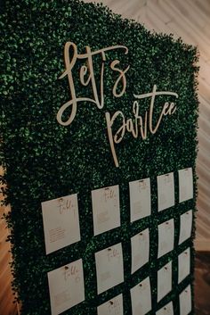 a green wall covered in lots of notes and writing on it's side with the words let's party written on it