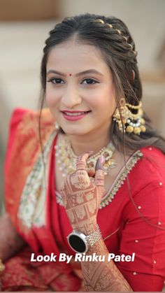 a woman in red dress sitting down with her hands on her chest and fingers crossed