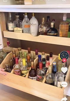 a wooden cabinet filled with lots of bottles