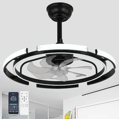 a ceiling fan that is mounted to the ceiling in a room with white walls and flooring