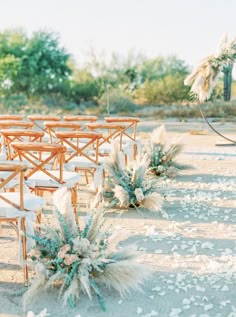 an outdoor wedding set up with chairs and flowers