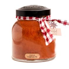 a glass jar filled with red sauce on top of a white table