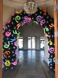 an arch decorated with balloons and streamers