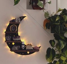 a moon shelf with candles and rocks on it