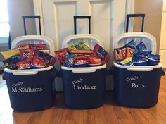 three coolers filled with candy and snacks sitting on the floor