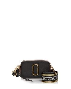 a black cross body bag with the letter c on it and a gold chain strap