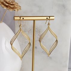 Elevate your fall style with our exquisite Filigree Ribbon Geometric Rectangle-Drop Dangle Earrings, a masterpiece of elegance and artistry. Crafted to perfection, these earrings seamlessly blend modern sophistication with intricate filigree detailing, creating a captivating accessory that complements your seasonal attire.Each earring weighs a mere 8 grams, ensuring a comfortable wear throughout the day and evening. The lightweight feel doesn't compromise on the substantial impact these earrings Elegant Metal Linear Earrings For Evening, Elegant Rectangular Hoop Earrings For Formal Occasions, Elegant Rectangular Linear Earrings As Gift, Elegant Rectangular Linear Earrings For Gift, Elegant Metal Linear Earrings For Formal Occasions, Vintage Style Filigree Drop Earrings For Evening, Vintage Filigree Drop Earrings For Evening, Rectangular Earrings For Evening, Evening Filigree Drop Earrings