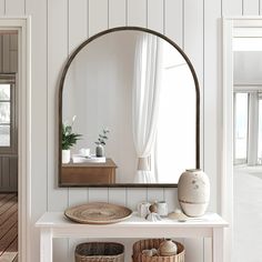 a mirror and some baskets on a table