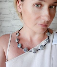 Choker necklace with large (12 mm) round gray-blue ceramic beads. Ceramic beads in a necklace are round, disc-shaped, embossed. Quite heavy and fit well on the décolleté. Choker necklace with ceramic beads and PVC cord is very pleasant to the touch. Large beads are complemented by small beads of faceted hematite. Necklace on a semi-rigid basis, keeps its shape well. Carabiner clasp All decorations are packed in a craft gift box, they will be a great gift for an anniversary, birthday or any other holiday. CARE 1. Try not to drop it so that the ceramic beads do not break 2. Keep away from fire and do not leave in direct sunlight for a long time Unique Choker Necklaces, Unique Choker, Choker Necklace Black, Large Bead Necklace, Large Beads, Black Minimalist, Hematite Necklace, Black Choker Necklace, Ceramic Necklace