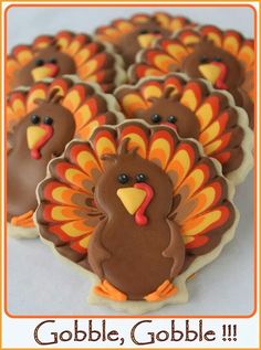 decorated cookies in the shape of turkeys with words gobble, gobble