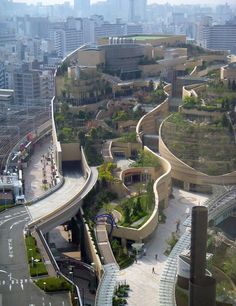 an aerial view of a city with many buildings and trees on the side of it