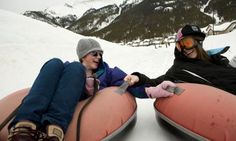 two people sitting on bean bags in the snow