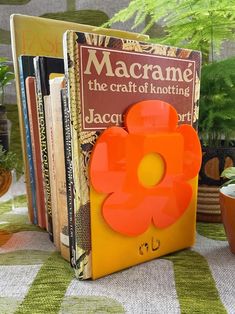 there is a bookend made out of an orange flower