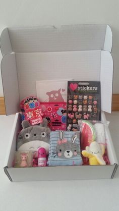 an open box filled with lots of toys and stuff animals on top of a table