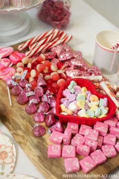 valentine's day candy bar with pink and white candies, lollipops, marshmallows