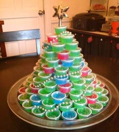 a christmas tree made out of cups on top of a tray with the words, i'm'm's tree this year with ten soda and 4 others