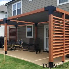 a patio covered in wooden slats next to a house