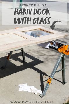 an outdoor table with the words how to build a barn door with glass on it