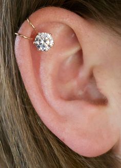 This dramatically Blingy Ear Cuff fits without piercing on your upper cartilage and simulates a pierced cartilage. It shows off a very big and sparkly prong set 7mm Cubic Zirconia. It fits you high ear comfortably and securely. We use only the highest quality metals, 14K Gold Filled and Sterling Silver. This Ear Cuff will fit either ear. This piece will arrive in a Gift Box and include simple fitting instructions. Perfect for gift giving Minimalist Ear Cuff, Gold Toe Rings, Cartilage Ear Cuff, Helix Ear, Wrap Earrings, Unusual Jewelry, Ear Cuffs, Engraved Jewelry, Cuff Earrings