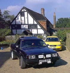 two cars parked next to each other in front of a house