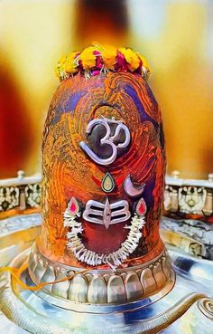 an intricately decorated decorative object with the omesh symbol on it's face