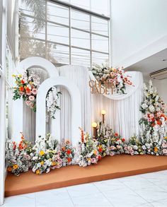 the entrance to an event decorated with flowers