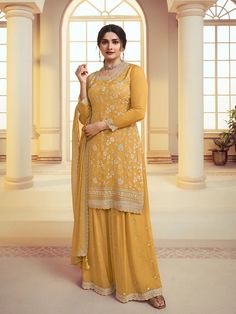 Get ready to turn heads with this Yellow Floral Pattern Embroidered Palazzo Suit Set! Expertly crafted with intricate embroidery, sequins, and resham thread work, this palazzo style salwar suit is the epitome of chic style. A matching bottom and dupatta finishes off the look with perfection. 3 piece with lining (Top, Bottom, Dupatta) Kameez chinon silk with heavy embroidery work Palazzo chinon silk with embroidery front and back Dupatta chinon silk with four side lace and all over embroidery work Work: resham thread work, sequin work, lace Style: straight cut Kameez with side zipper Santoon lining Kameez Length: 42" Palazzo Length: 41" Sleeves length: 22" Dupatta: 2.25 meter Waistband: full elastic waist band Occasion: weddings, sangeet, festival wear, party wear, sangeet, haldi Condition: Traditional Long Sleeve Palazzo Set With Gold Embroidery, Elegant Yellow Sharara With Floral Embroidery, Festive Long Sleeve Palazzo Set With Gold Embroidery, Semi-stitched Anarkali Palazzo Set With Gold Embroidery, Anarkali Style Semi-stitched Gold Embroidered Palazzo Set, Anarkali Palazzo Set With Gold Embroidery, Semi-stitched Gold Embroidered Palazzo Set For Eid, Semi-stitched Palazzo Set With Gold Embroidery For Eid, Fitted Gold Embroidery Palazzo Set