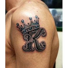 a man with a crown tattoo on his shoulder